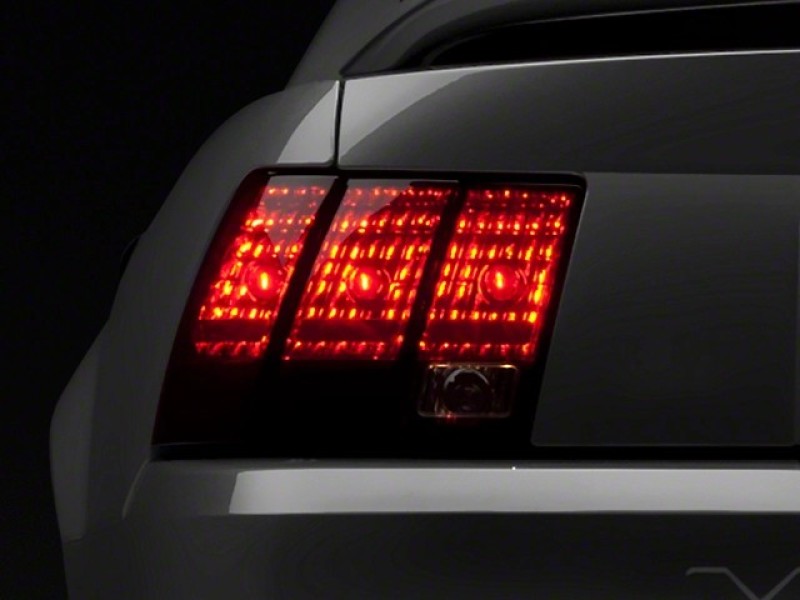Raxiom 49080 99-04 Ford Mustang Excluding 99-01 Cobra Tail Lights- Black Housing (Smoked Lens)
