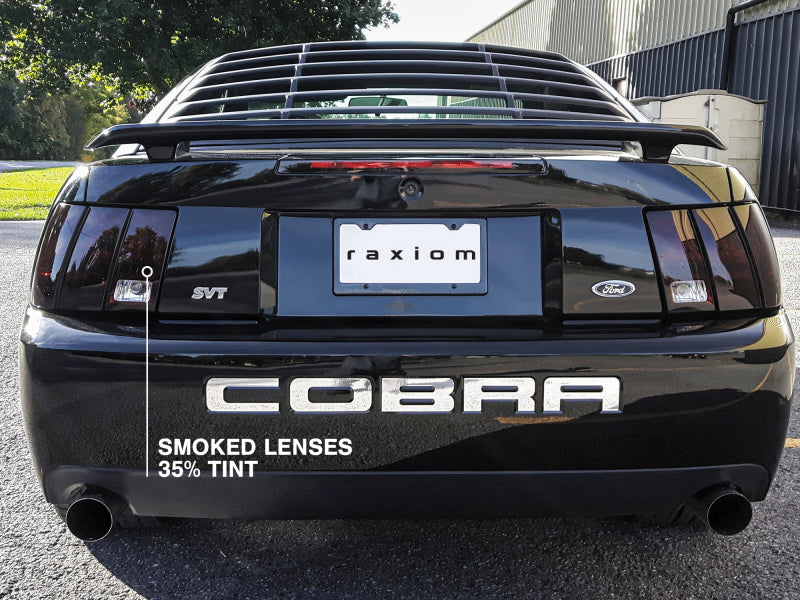 Raxiom 49080 99-04 Ford Mustang Excluding 99-01 Cobra Tail Lights- Black Housing (Smoked Lens)