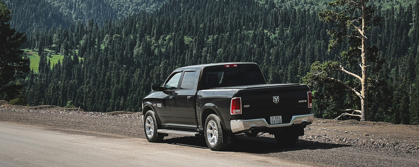 Black RAM 1500 on a mountain road — RAM 1500 Tonneau Cover Fitment Guide