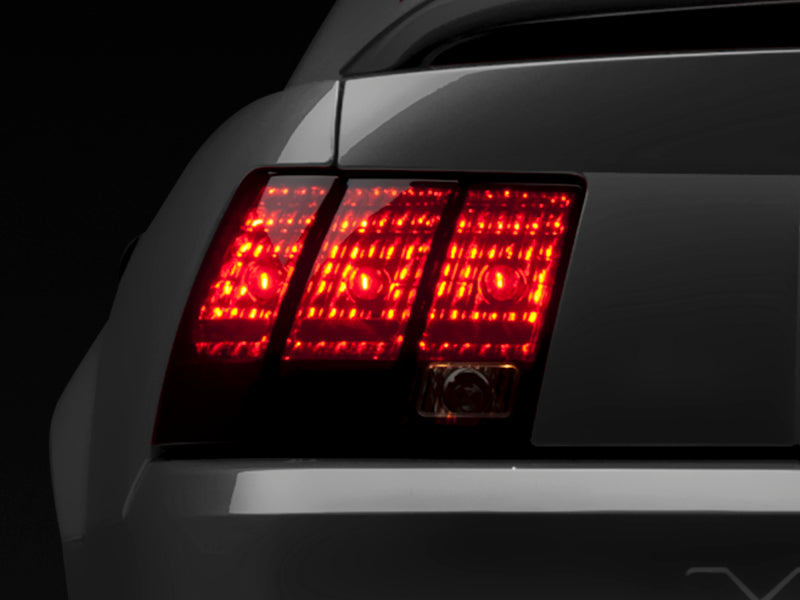 Raxiom 49080 99-04 Ford Mustang Excluding 99-01 Cobra Tail Lights- Black Housing (Smoked Lens)
