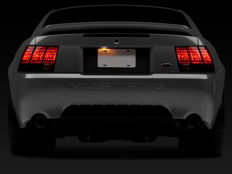 Raxiom 49080 99-04 Ford Mustang Excluding 99-01 Cobra Tail Lights- Black Housing (Smoked Lens)