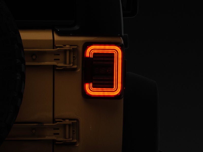 Raxiom J138358 07-18 Jeep Wrangler JK Axial Series LED Halo Tail Lights- Black Housing (Dark Smoked Lens)