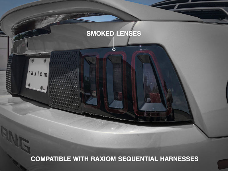 Raxiom 100807 99-04 Ford Mustang Excluding 99-01 Cobra Icon LED Tail Lights- Black Housing (Smoked Lens)