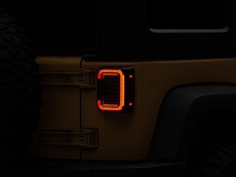 Raxiom J138358 07-18 Jeep Wrangler JK Axial Series LED Halo Tail Lights- Black Housing (Dark Smoked Lens)