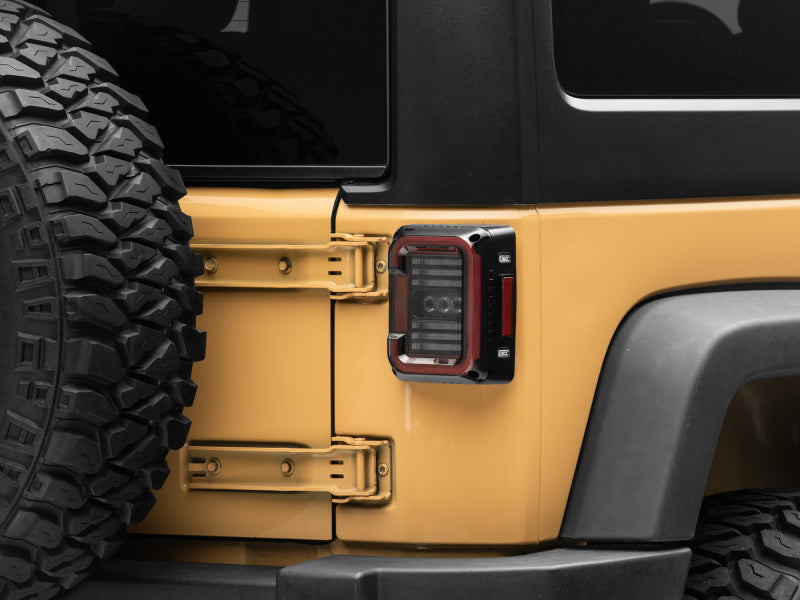 Raxiom J138358 07-18 Jeep Wrangler JK Axial Series LED Halo Tail Lights- Black Housing (Dark Smoked Lens)